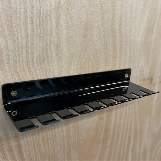 Black metal bracket on a wooden surface